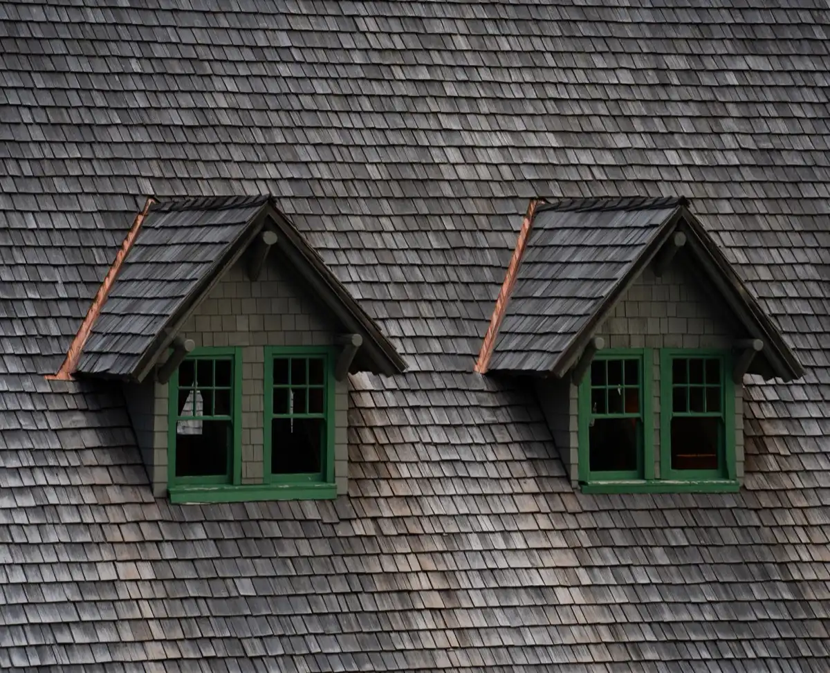 Dormers on a shingle roof in Keller, TX, where step flashing and kickout flashing carry water past the walls