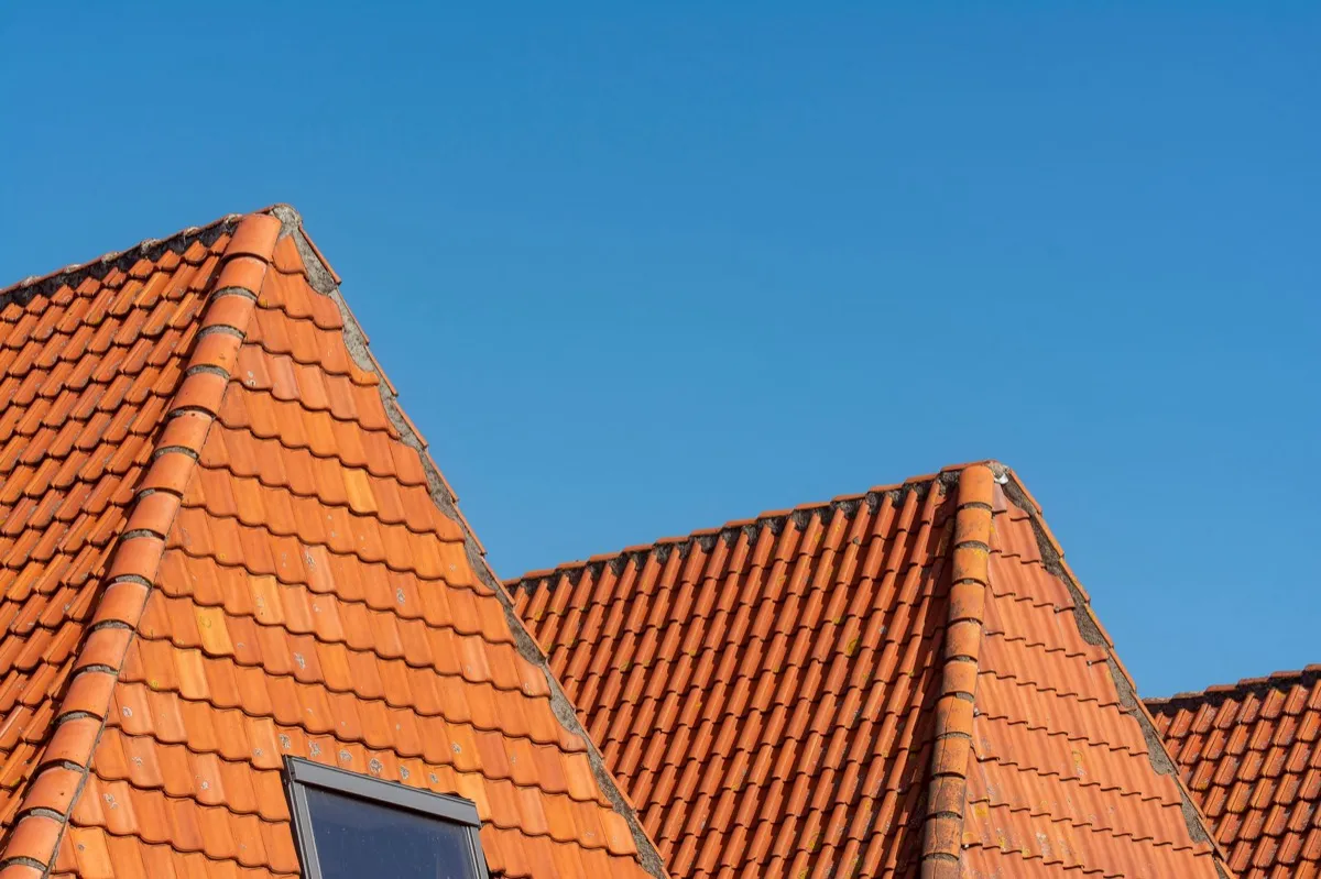 Clay barrel tile rooflines on homes in Keller, TX